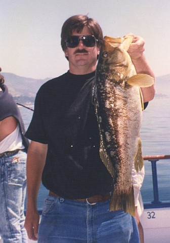 Peter holding a 24-inch calico bass