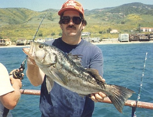 Peter holding a 23.5 inch calico bass