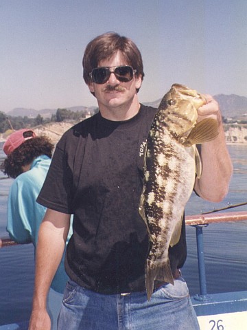 Peter holding a 20-inch calico bass