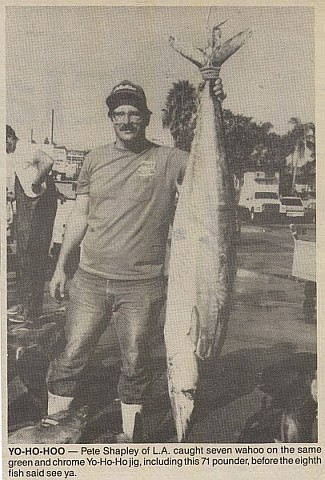 Newspaper clipping of Peter standing by a wahoo hanging on a scale