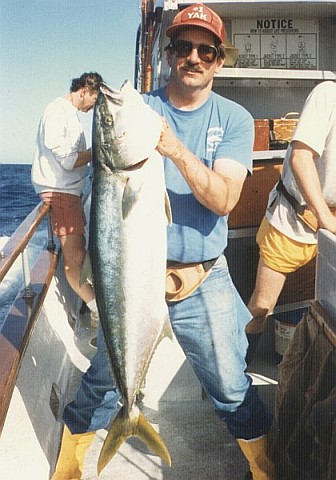 Peter holding a 4-foot-long yellowtail